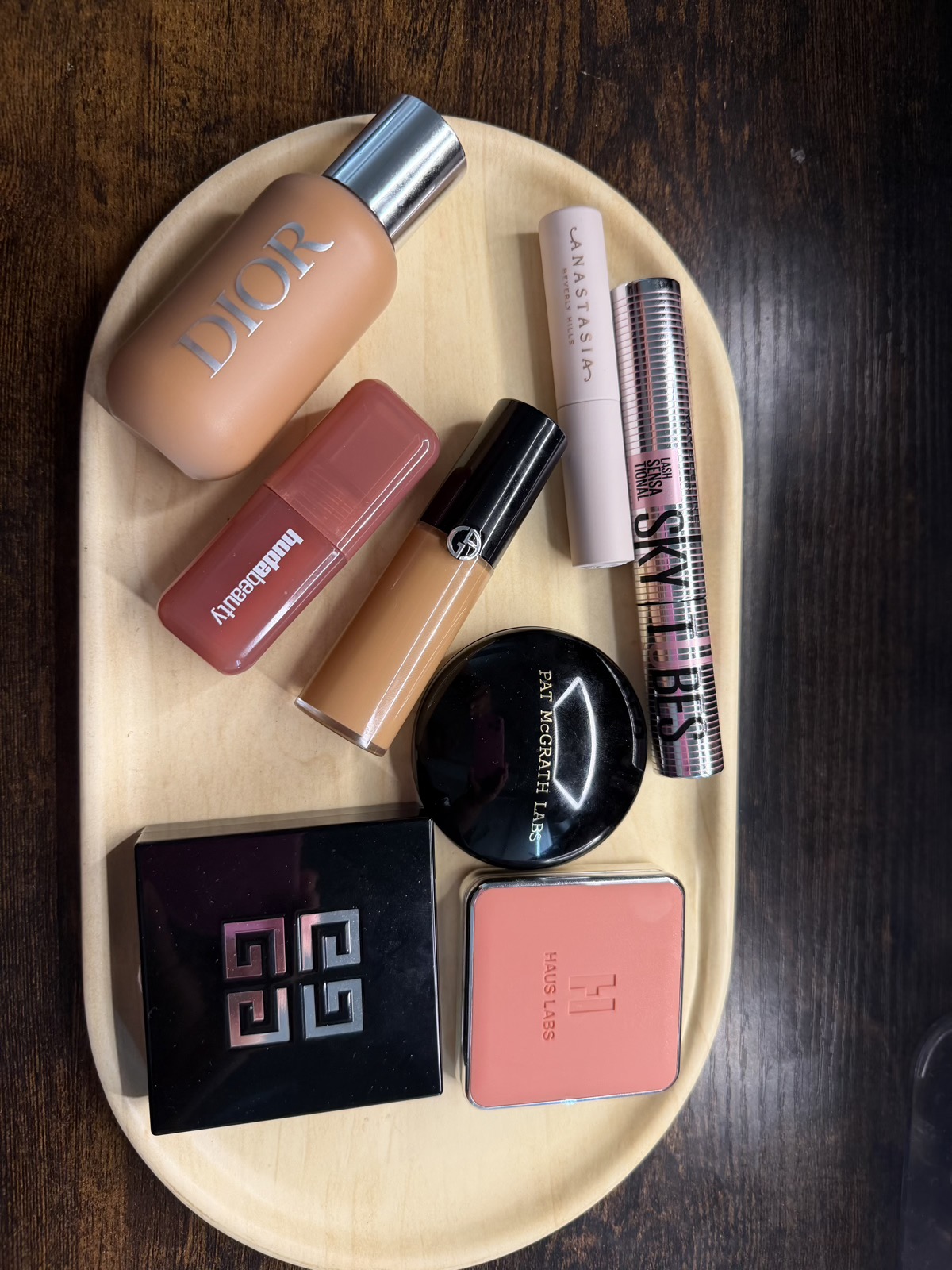 Soft neutral flat lay of skincare and beauty products on linen
